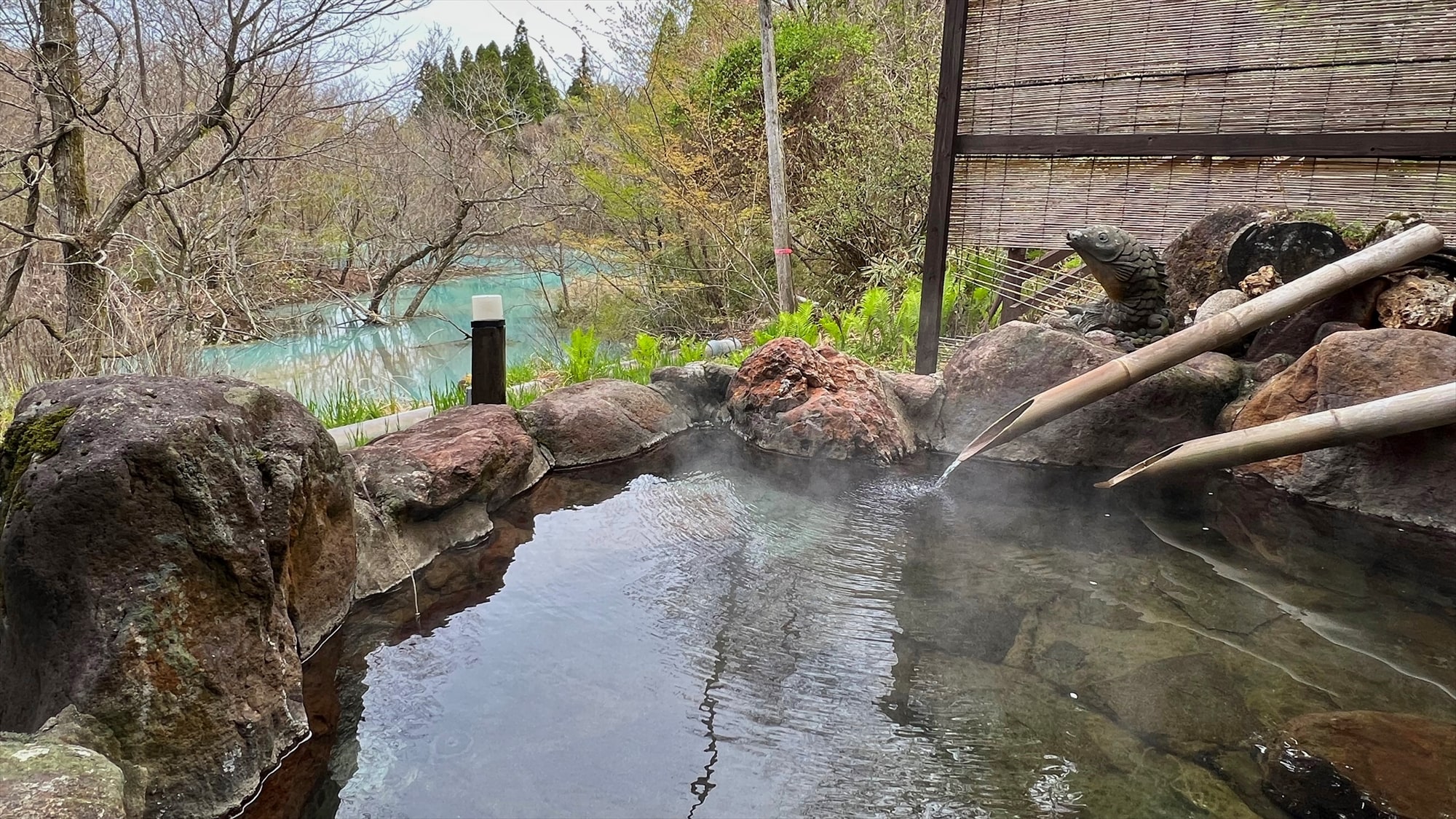 Private bath: View of the mountain stream from the open-air bath. The hot spring ingredients turn the river cobalt blue!