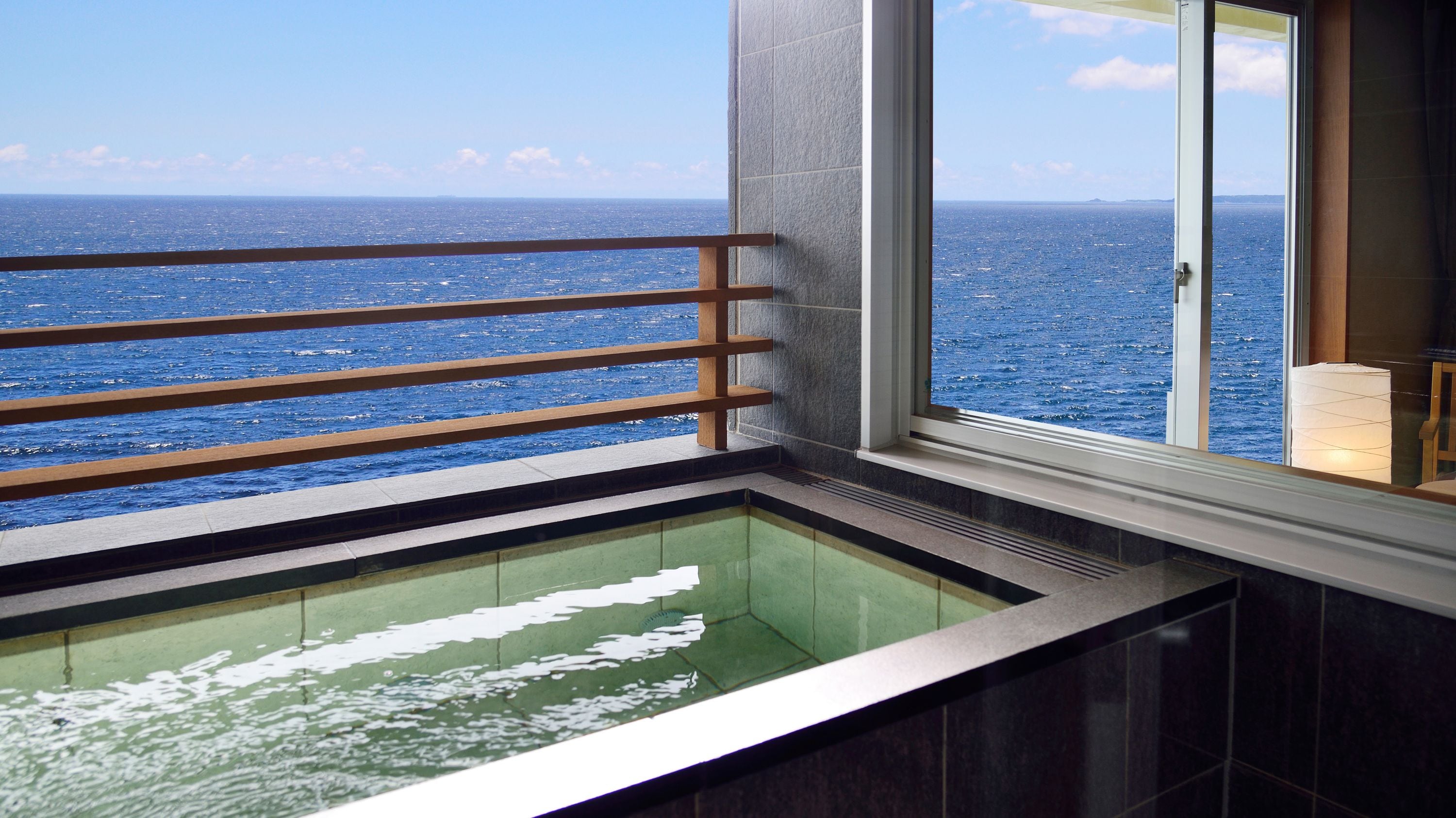 Premium floor guest room open-air bath with a panoramic view of the sea