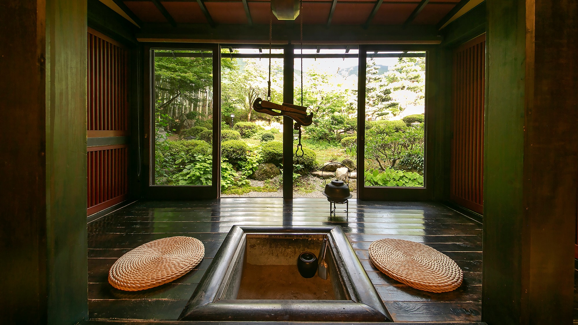 A wide veranda with a hearth overlooking the lush greenery. Relax with the gentle heat.
