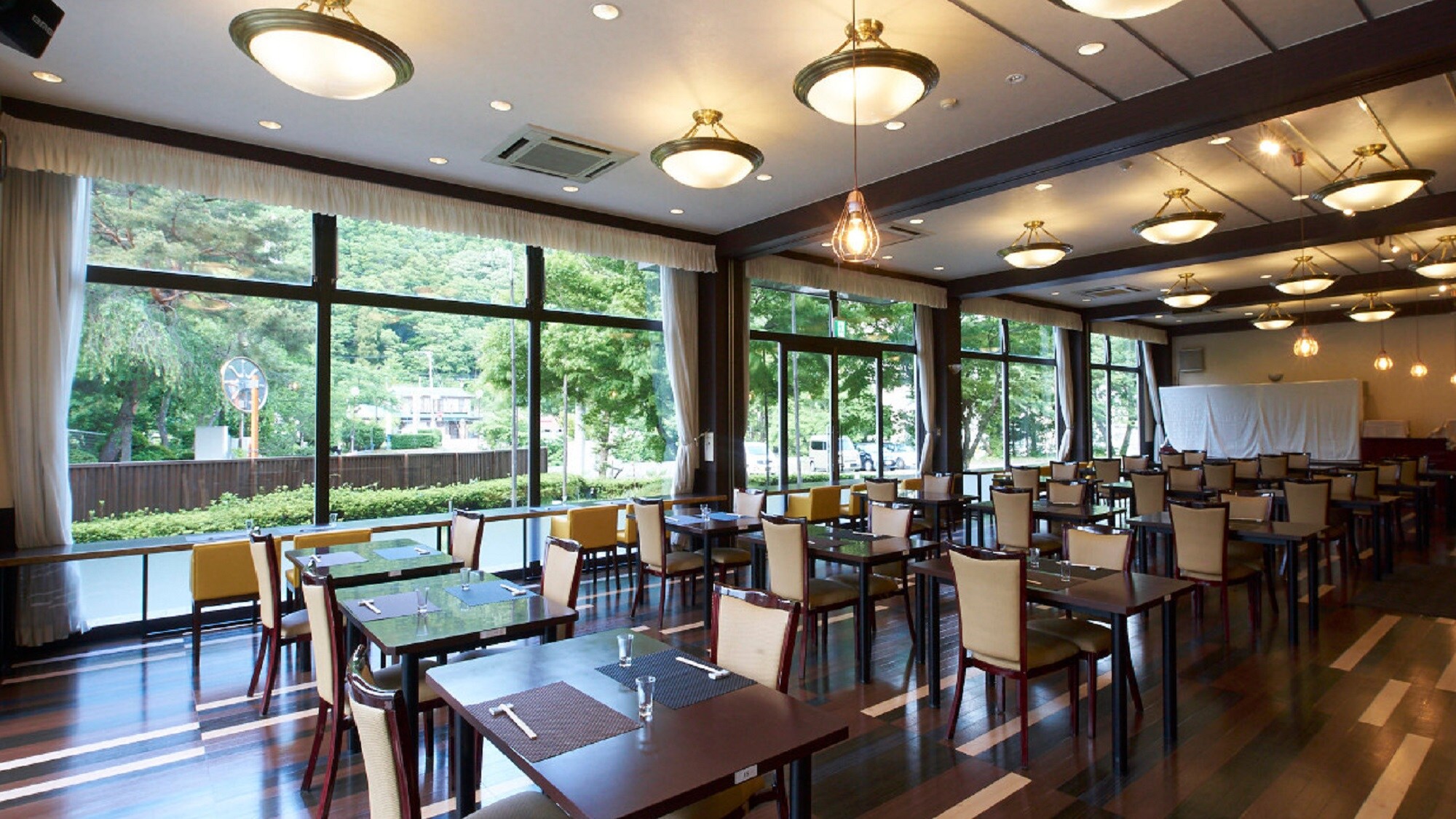 [Restaurant] A warm and cozy restaurant with sunlight filtering through the trees