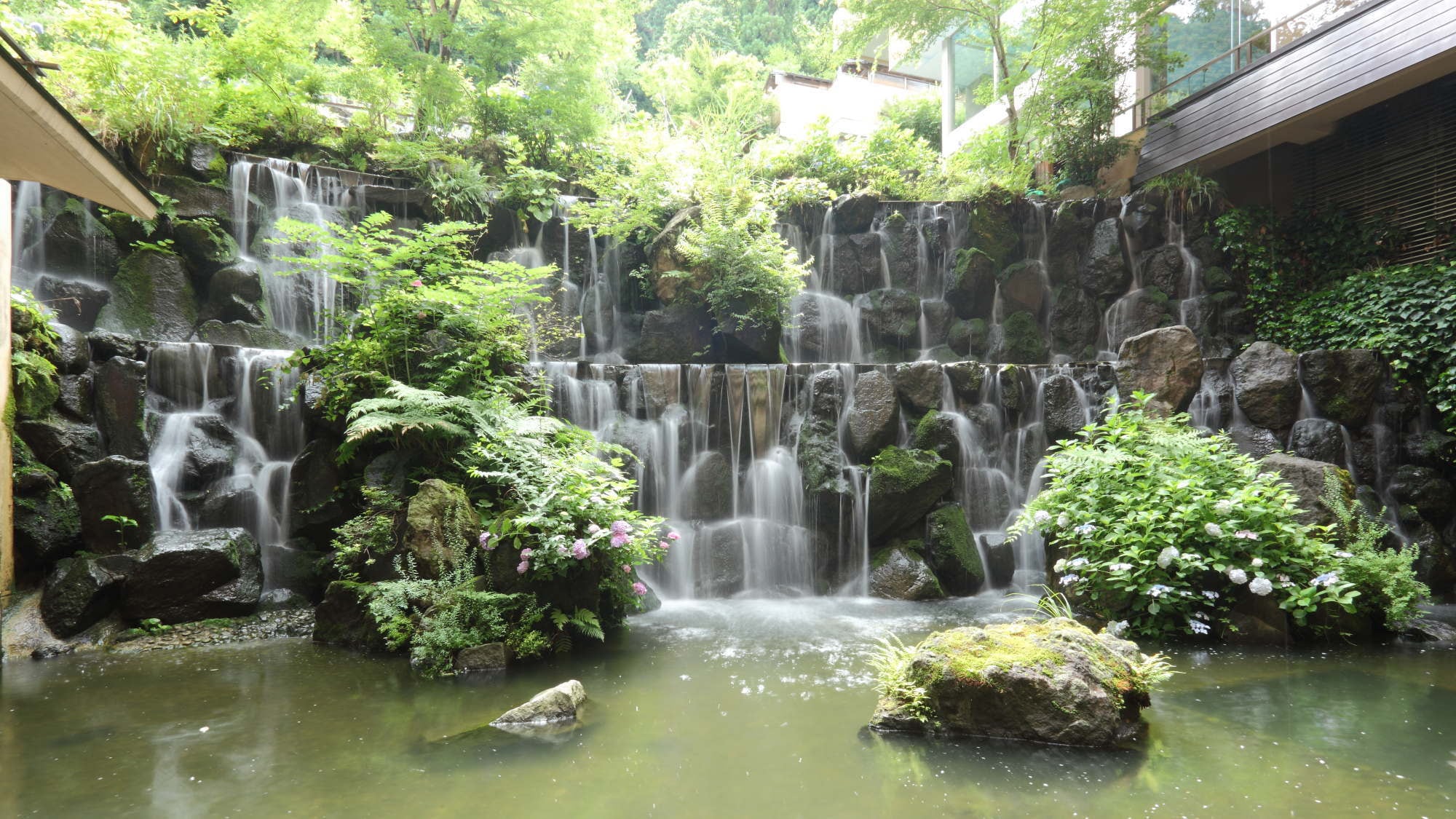 [Lobby] A waterfall flows through the large lounge when you enter the building.