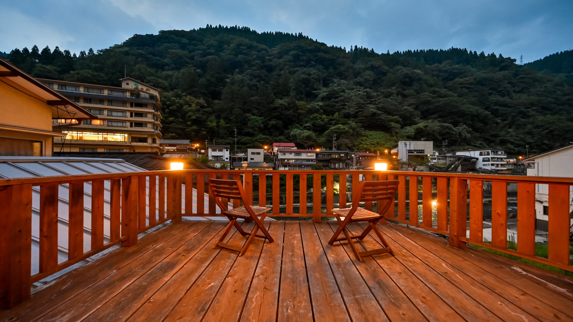 [Japanese-style room with terrace] Enjoy a relaxing time on the warm wooden terrace, surrounded by the tranquil mountain village scenery.