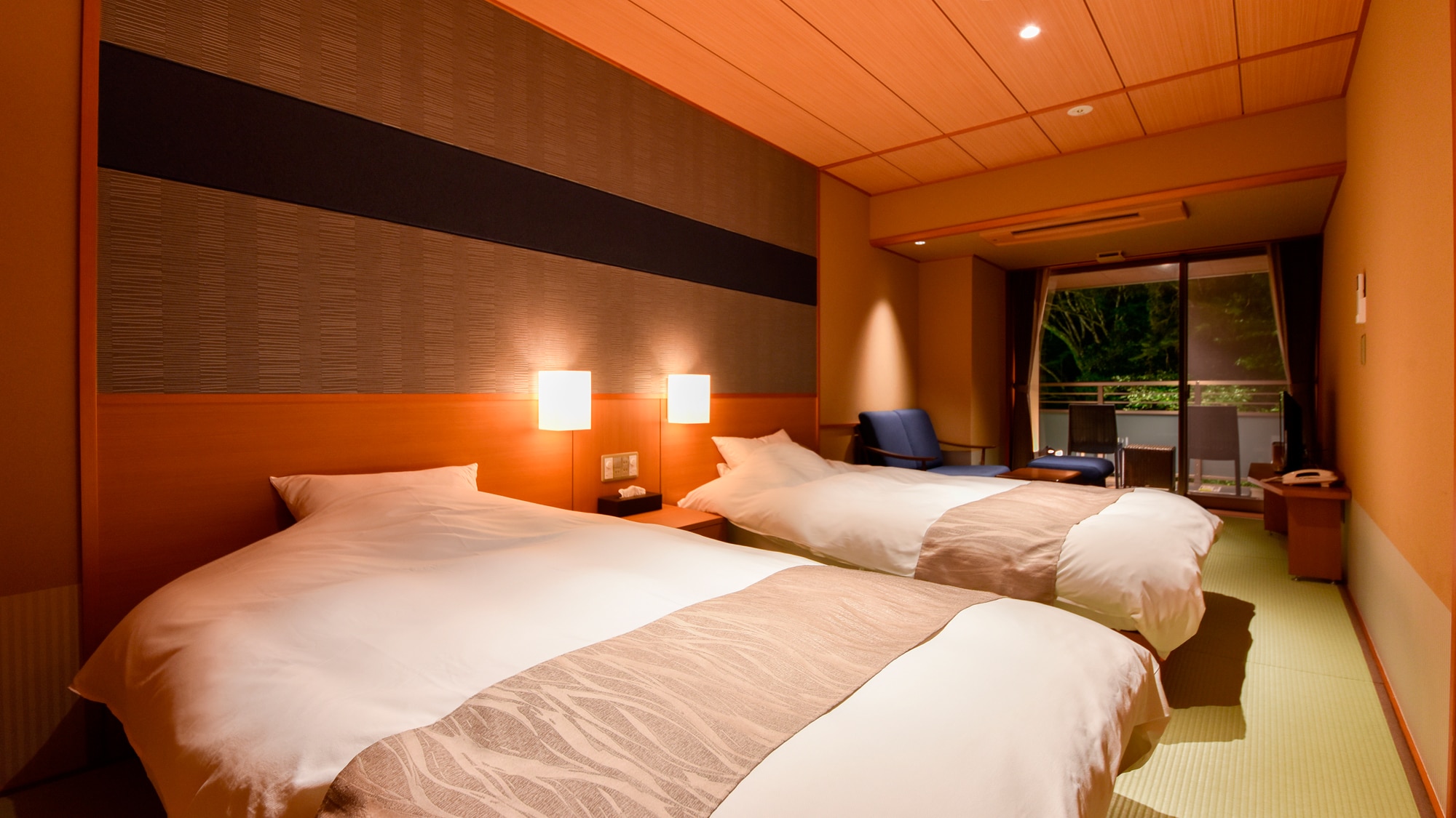 [Main building, Japanese-style room with private source A] A room with a twin bed, sofa and terrace at night and in a Japanese-style room.