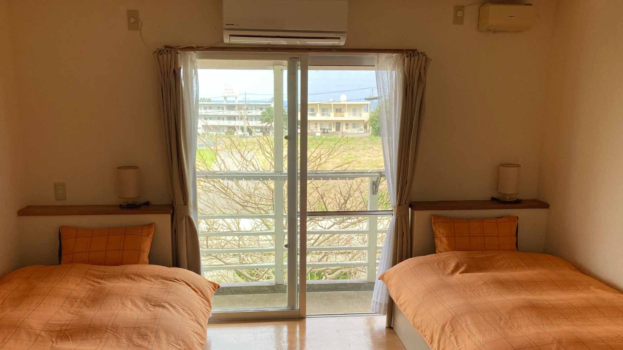 ・Ocean View Twin Room: A spacious, relaxing space with large windows and high ceilings.