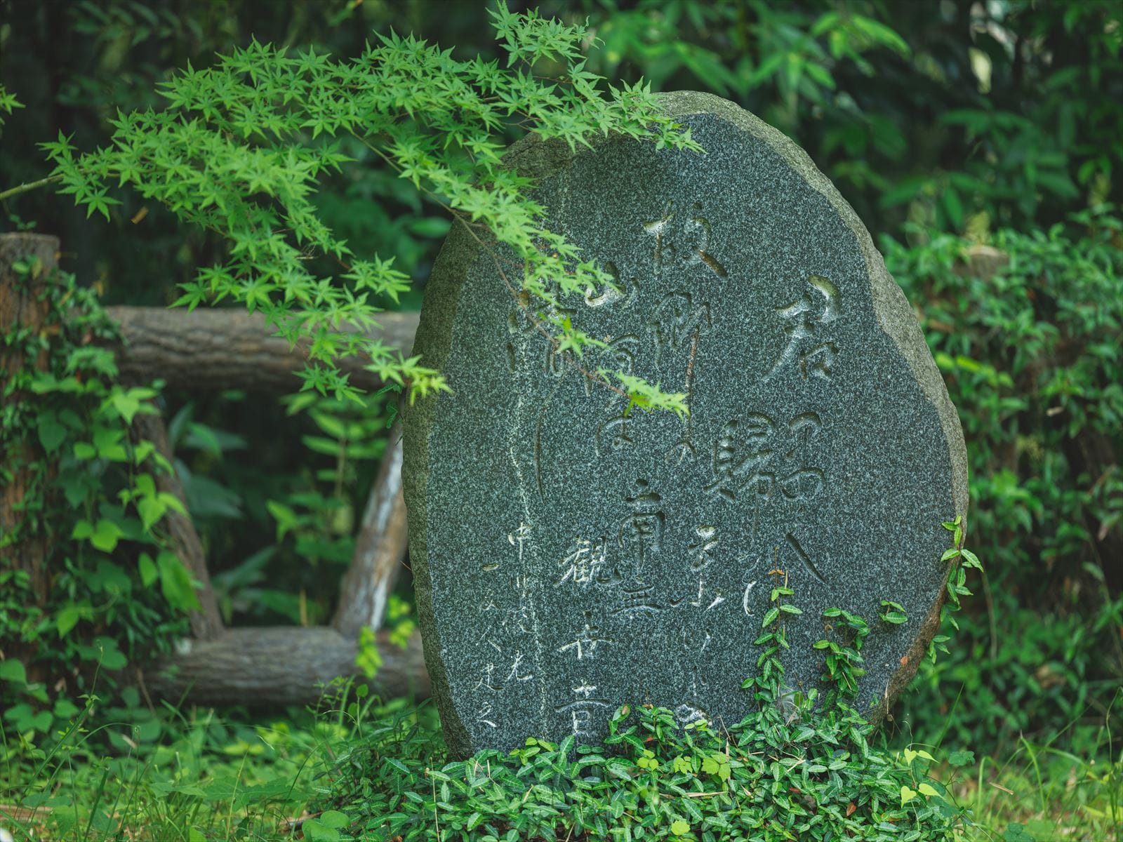 A stone monument on the lakeside literary path